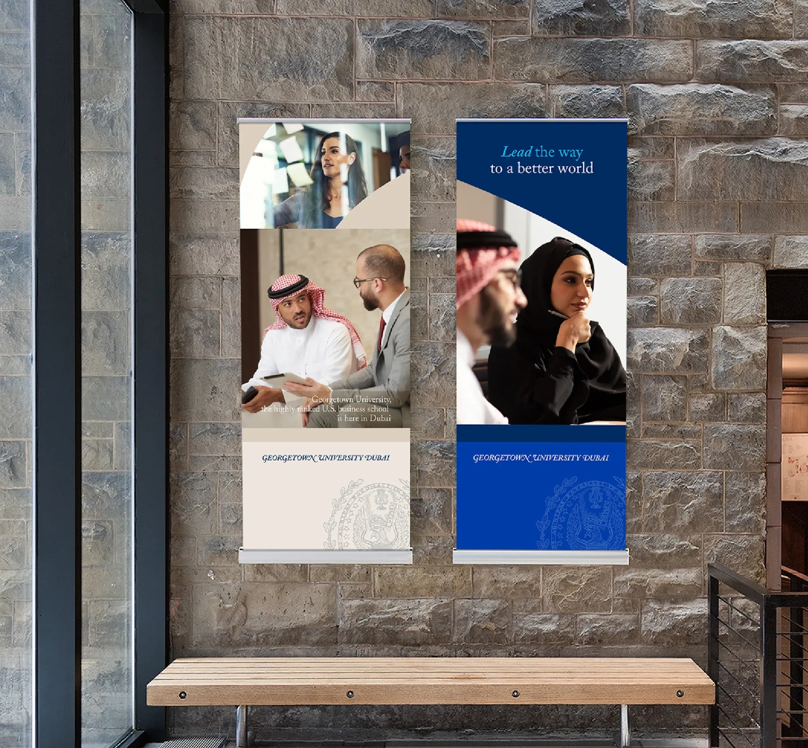 Two vertical banners for Georgetown University Dubai on a stone wall. Skyne specializes in comprehensive branding solutions and marketing collateral for educational institutions in Dubai, Riyadh, and Jeddah.